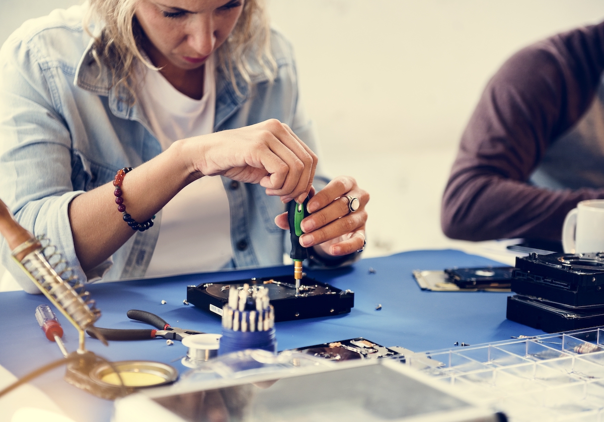 Technicians working on computer hard disk